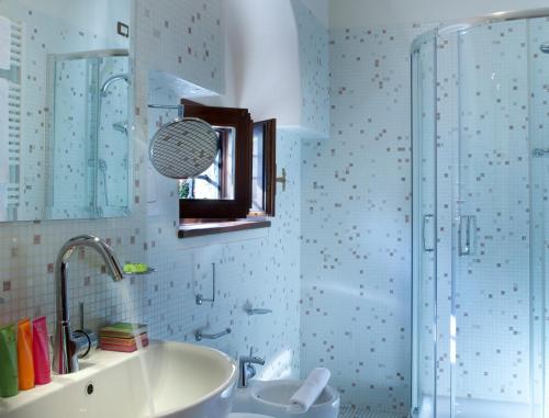 a bathroom with a sink and a shower at Hotel Villa Giulia in Gargnano