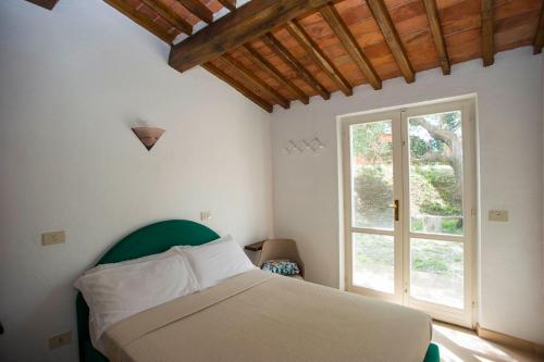 Un pat sau paturi într-o cameră la Il Poggio Marcuccio