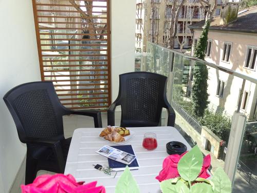 a table with a plate of food on a balcony at Hotel Villa Enea in Cattolica