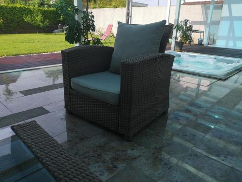 a brown wicker chair sitting on a patio at Homestay Free Park&Bikes in Ljubljana