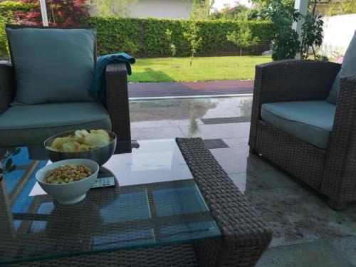 a table with a bowl of food and two chairs at Homestay Free Park&Bikes in Ljubljana