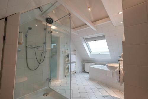 a bathroom with a shower and a sink at Hotel Savoy Hannover in Hannover