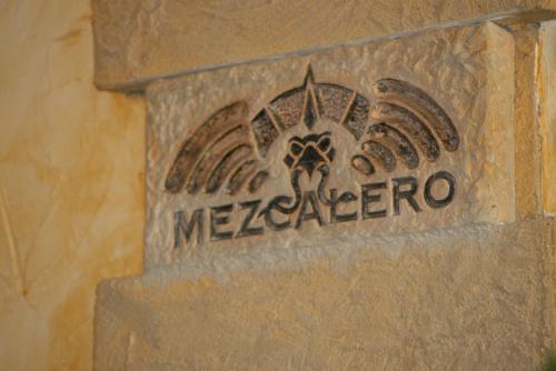 a sign on the side of a building with a meezez sign at Gästehaus Mezcalero in Dresden
