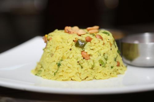 a plate of rice with nuts on it at Pai Viceroy in Tirupati