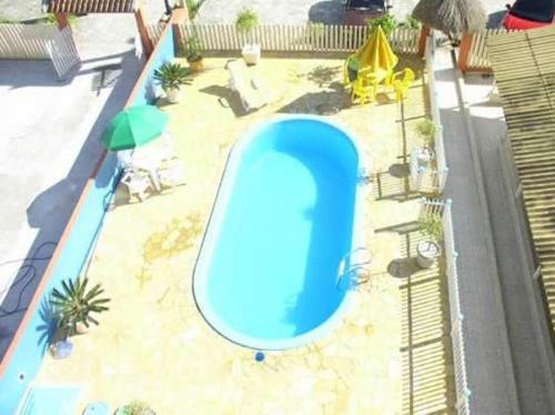 a beach with a pool and a pool table at Hotel Pousada Mineirinho in Balneário Praia do Leste