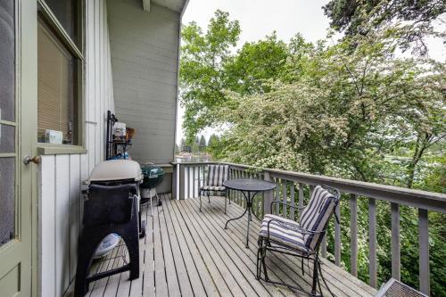 a porch with chairs and a table and a grill at Delake House in Otis
