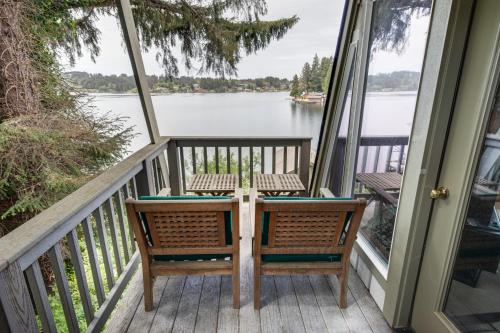 a balcony with a table and chairs on a house at Delake House in Otis