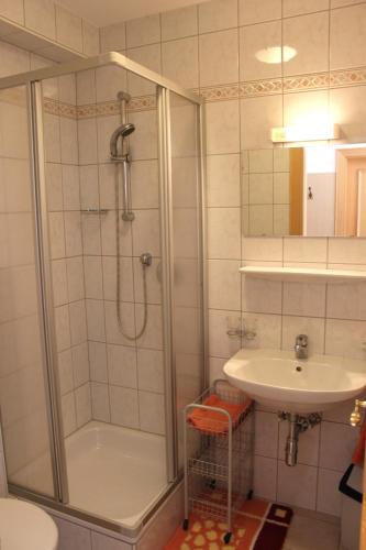 a bathroom with a shower and a sink at Ferienwohnungen Schöpf in Jerzens