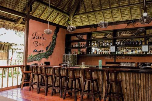 a bar with wooden stools in a restaurant at Tambopata Research Center in Tambopata