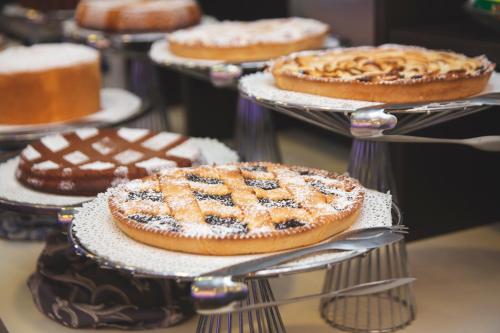 a group of pies on plates on a table at Hotel Gabbiano in Mola di Bari