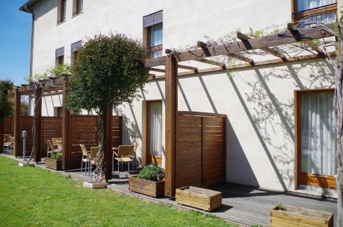 a house with a pergola and a patio at ibis Styles Carcassonne La Cité in Carcassonne