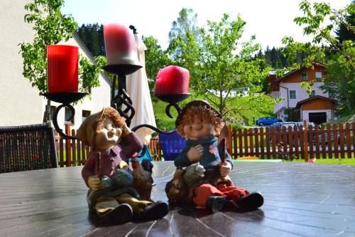 two figurines sitting on top of a table at Apartment Holiday Lungötz in Annaberg im Lammertal