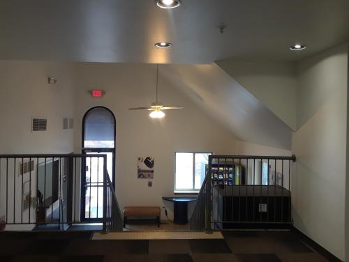 a room with a stairway with a ceiling at Welcome Suites Hazelwood Extended Stay Hotel in Hazelwood