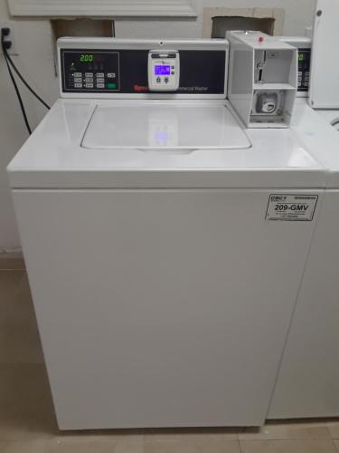 a white printer sitting on top of a machine at Welcome Suites Hazelwood Extended Stay Hotel in Hazelwood