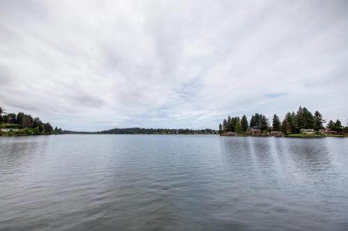 a large body of water with trees on the shore at Delake House in Otis