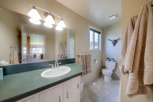 a bathroom with a sink and a toilet and a mirror at Apache Greens in Sisters