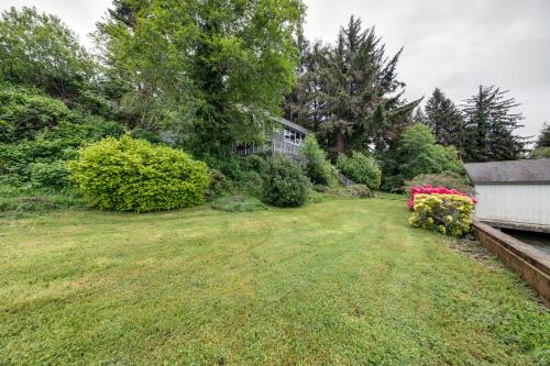 an empty yard with flowers and a house at Delake House in Otis