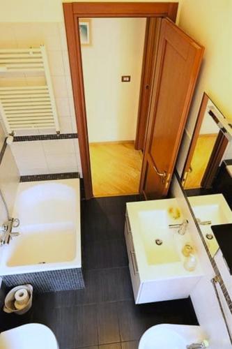 a bathroom with a sink and a tub and a toilet at Fairy Tales Ostia in Lido di Ostia