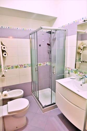 a bathroom with a shower and a toilet and a sink at Fairy Tales Ostia in Lido di Ostia