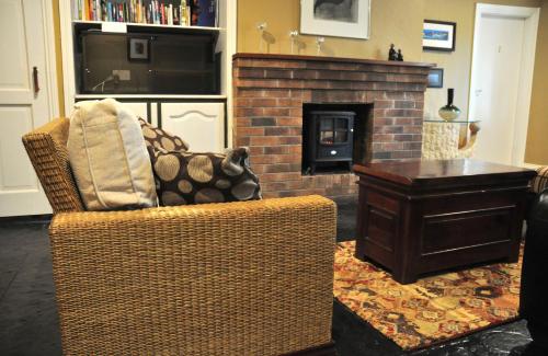 a living room with a chair and a fireplace at Killilagh Accommodation in Doolin