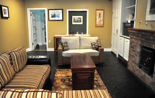 a living room with a couch and a fireplace at Killilagh Accommodation in Doolin