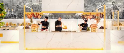 a group of chefs preparing food in a kitchen at Epirus Palace Congress & Spa in Ioannina