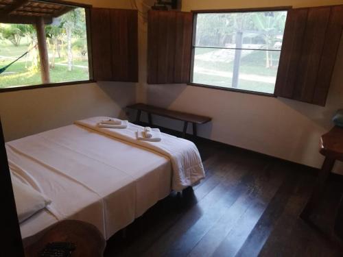 A bed or beds in a room at Pousada Rio das Almas