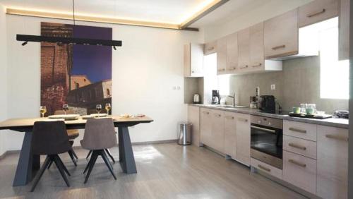 a kitchen with a table and chairs and a refrigerator at Athenian Residences in Athens