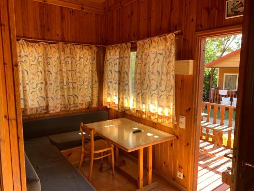 a dining room with a table and a balcony at Camping La Buganvilla in Marbella