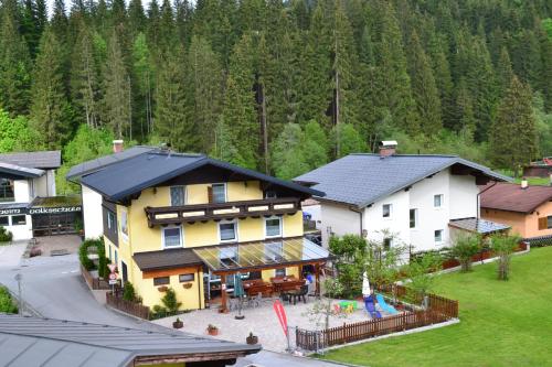 an aerial view of a large house with a playground at Pension Haus Rohrmoser in Annaberg im Lammertal