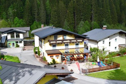 an aerial view of a house with a playground at Pension Haus Rohrmoser in Annaberg im Lammertal