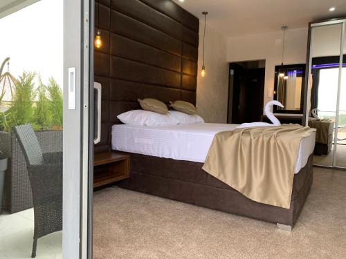 a bedroom with a large bed and a balcony at Apart Lux Beciragic in Dobra Voda