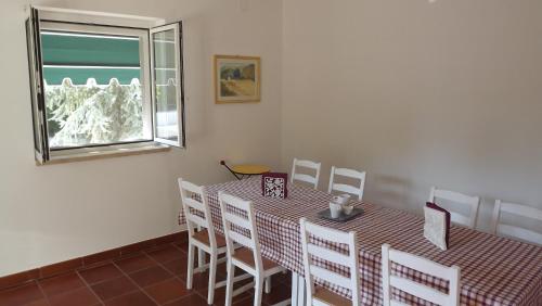 a dining room with a table and chairs and a window at Villa Apollonia B&B in Monopoli