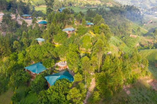 an aerial view of a house on a hill with trees at Rushaga Gorilla Lodge in Bugambira