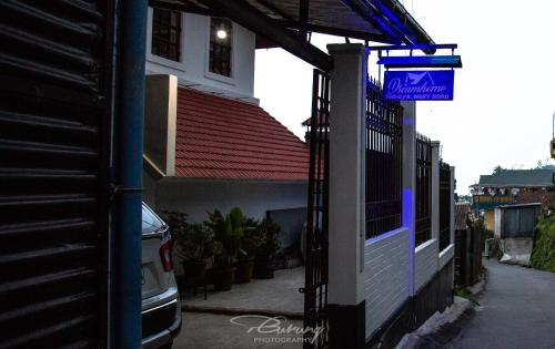 a building with a sign on the side of it at Dreamhome Stay in Kurseong
