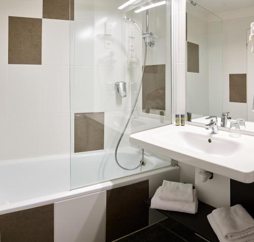 a bathroom with a sink and a shower at Best Western Hotel Wavre in Wavre