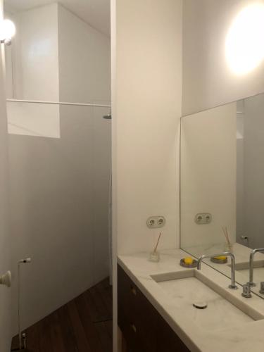 a bathroom with a sink and a mirror at Rua Tenente Campos Rego, Ground Floor in Coimbra