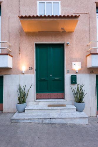 a green door on the side of a building at B&B Kalavrìa in Reggio Calabria