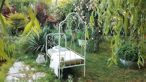 a swinging bed in a garden with plants at House Garden Loft in Baricella