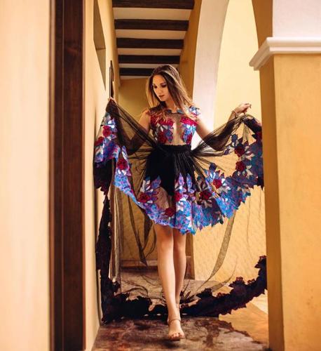 a woman in a dress walking down a hallway at Casa Sisal Valladolid Yuc in Valladolid