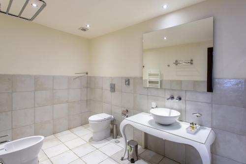 a bathroom with a sink and a toilet and a mirror at Residenza Wagner in Palermo