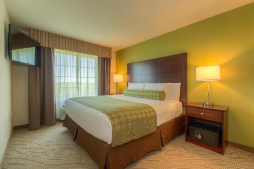 a hotel room with a large bed and a window at Cobblestone Inn & Suites - Holyoke in Holyoke