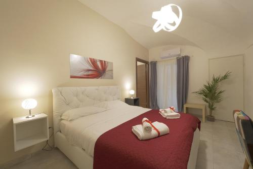 a bedroom with a bed with two towels on it at Le Dimore del Duomo in Catania