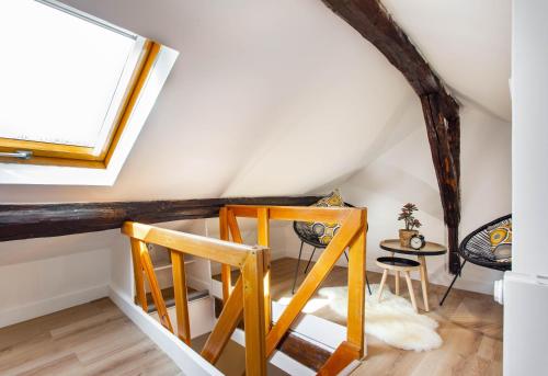 a room with a table and chairs in a attic at CMG Montorgueil V in Paris