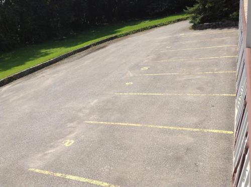 an empty parking lot with yellow lines in the road at Motel St-Thomas in Joliette