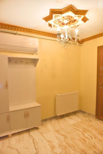a room with a chandelier and yellow walls at seasidehouse in Ordu