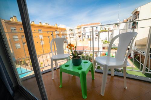 two chairs and a table on a balcony at Apartaments Atzavara in Calella