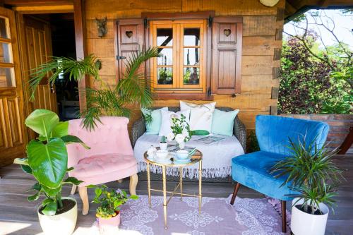 a patio with two chairs and a table with a bed at Villa Botanica in Mirkovec