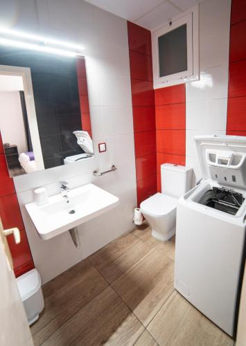 a small bathroom with a sink and a toilet at Apartaments Atzavara in Calella