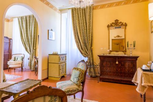 a living room with a dresser and a mirror at Hotel Villa Marsili in Cortona